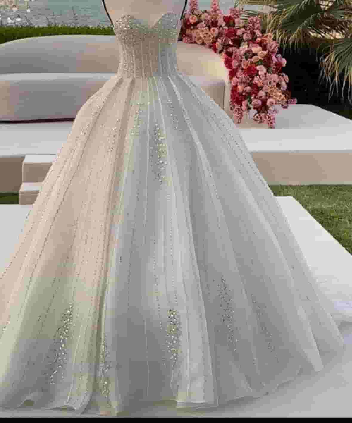 A wedding dress with a veil, a veil and a bride's abaya